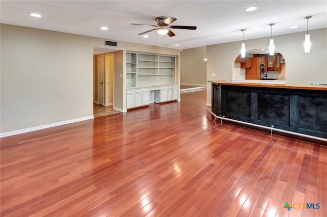 608 Chimney Rock Dr, Victoria, TX 77904 - bar featuring baseboards, ceiling fan, wood finished floors, recessed lighting, and arched walkways