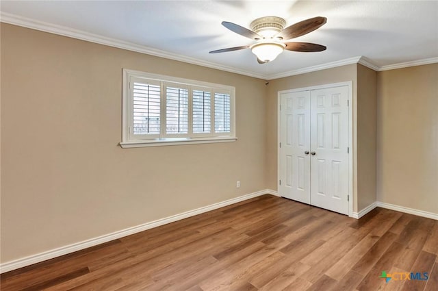 608 Chimney Rock Dr, Victoria, TX 77904 - unfurnished bedroom featuring wood finished floors, baseboards, crown molding, a closet, and a ceiling fan