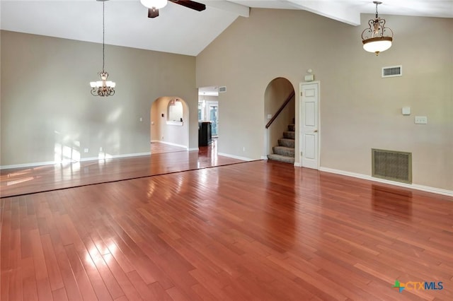 608 Chimney Rock Dr, Victoria, TX 77904 - unfurnished living room with ceiling fan, arched walkways, high vaulted ceiling, wood finished floors, and beamed ceiling