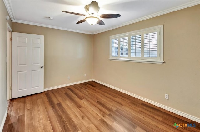 608 Chimney Rock Dr, Victoria, TX 77904 - spare room with wood finished floors, a ceiling fan, baseboards, ornamental molding, and a smoke detector