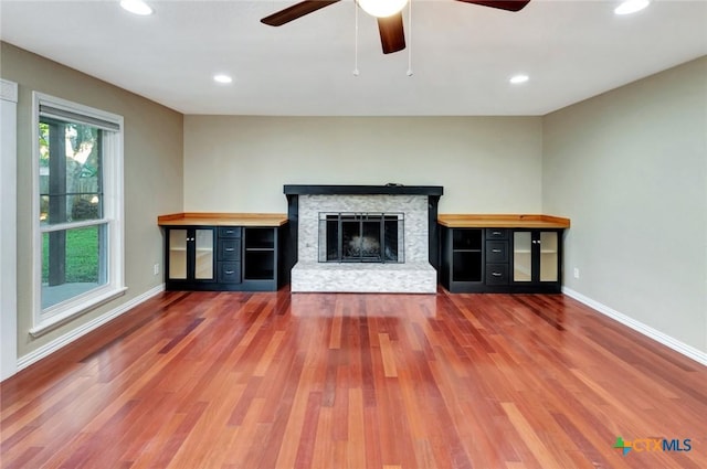 608 Chimney Rock Dr, Victoria, TX 77904 - unfurnished living room featuring ceiling fan, wood finished floors, baseboards, recessed lighting, and a fireplace