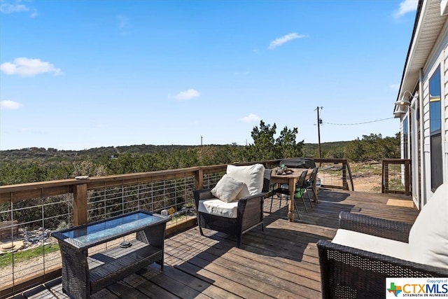 wooden deck with an outdoor living space