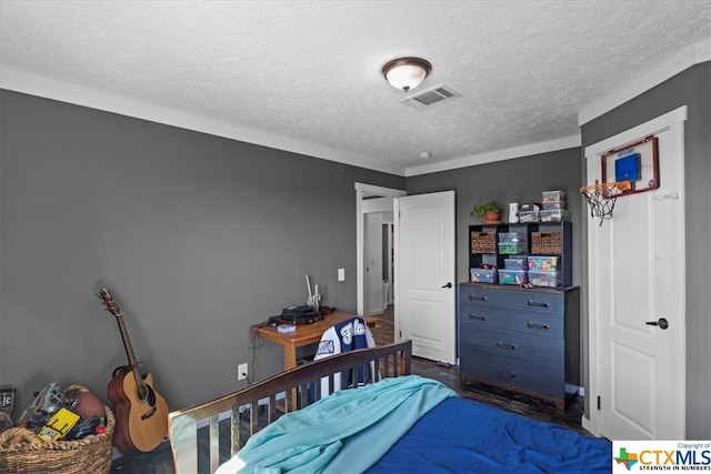 bedroom featuring dark hardwood / wood-style floors and a textured ceiling