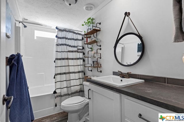 full bathroom with shower / bath combination with curtain, a textured ceiling, wood-type flooring, vanity, and toilet