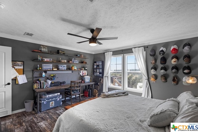 bedroom featuring a textured ceiling, dark wood-type flooring, and ceiling fan