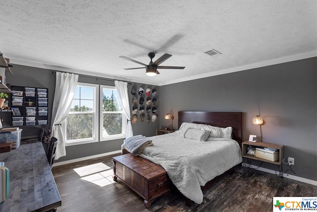 bedroom featuring a textured ceiling, ornamental molding, dark hardwood / wood-style floors, and ceiling fan