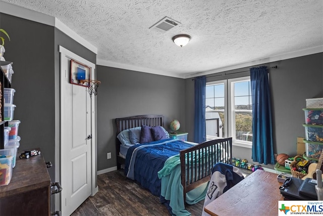 bedroom featuring dark wood-type flooring, a textured ceiling, and ornamental molding