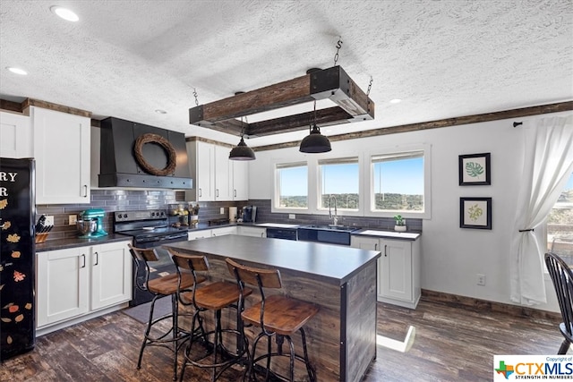 kitchen featuring dark wood-type flooring, white cabinetry, and custom range hood