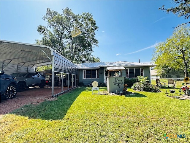 27 County Road 398, TX 77987 - back of property featuring a yard, a detached carport, and metal roof