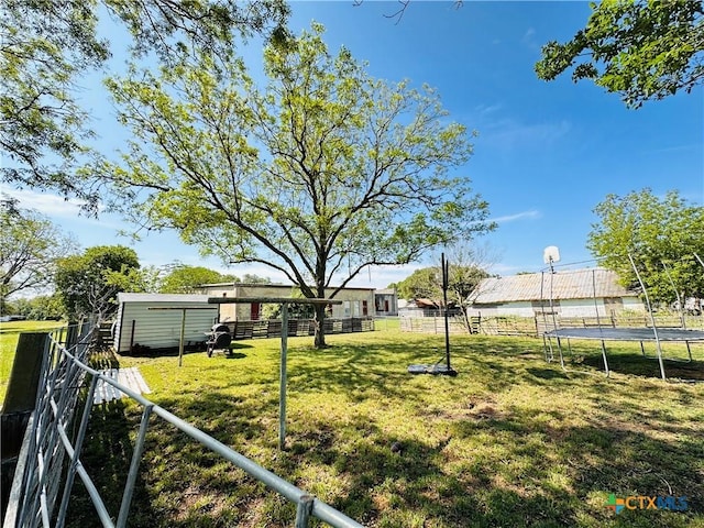 27 County Road 398, TX 77987 - view of yard featuring a trampoline and fence