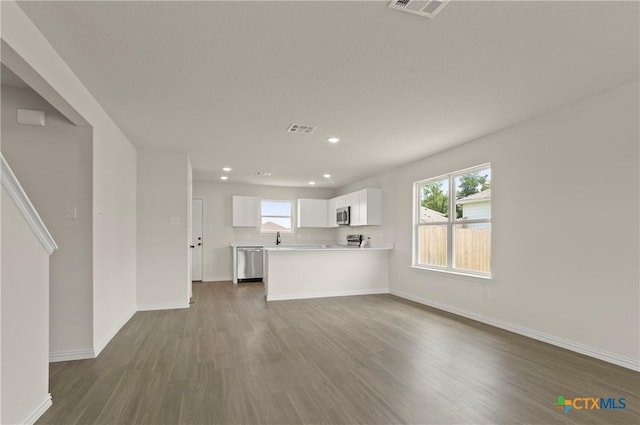 3820 Keller Rd, Temple, TX 76504 - unfurnished living room with dark wood-style floors, recessed lighting, and plenty of natural light