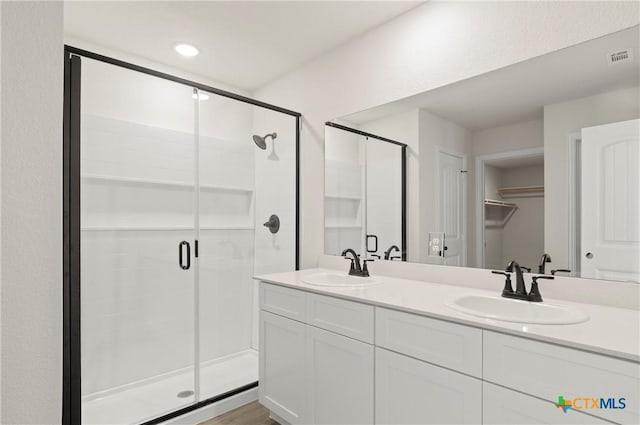 3820 Keller Rd, Temple, TX 76504 - full bathroom featuring a shower stall, double vanity, and a spacious closet