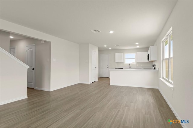 3820 Keller Rd, Temple, TX 76504 - unfurnished living room featuring wood finished floors and recessed lighting