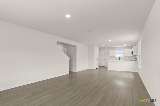 3820 Keller Rd, Temple, TX 76504 - unfurnished living room with wood finished floors and recessed lighting