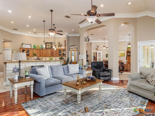 living room with light hardwood / wood-style floors and crown molding