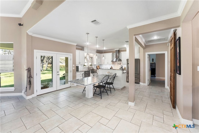 dining area featuring french doors and crown molding