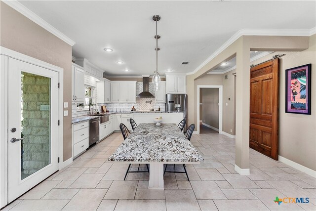 dining room with sink and ornamental molding