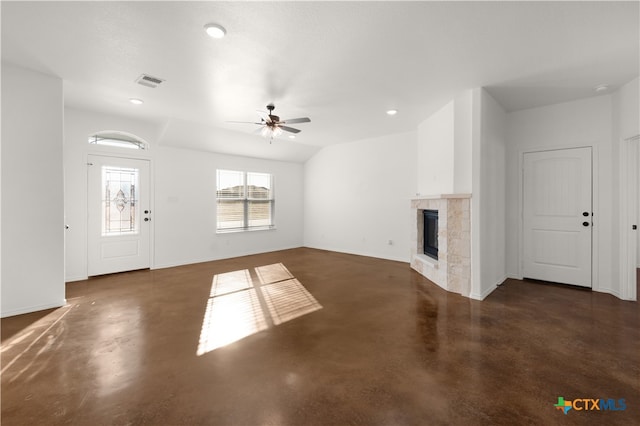 unfurnished living room with ceiling fan and a tile fireplace