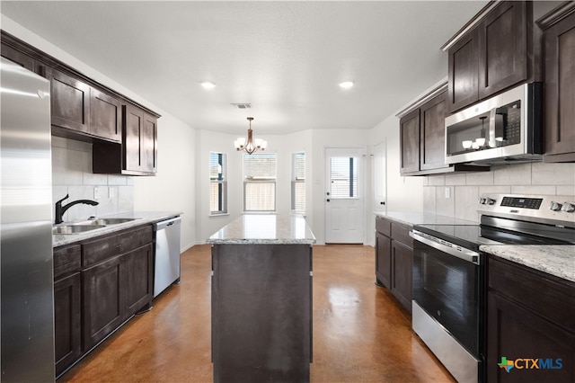 kitchen with tasteful backsplash, sink, an inviting chandelier, and appliances with stainless steel finishes