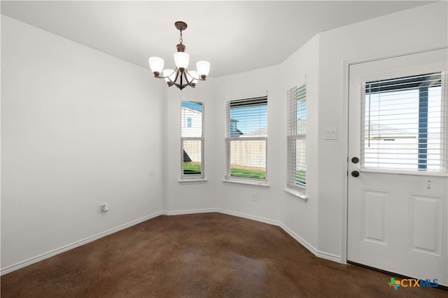 interior space with dark colored carpet, plenty of natural light, and an inviting chandelier