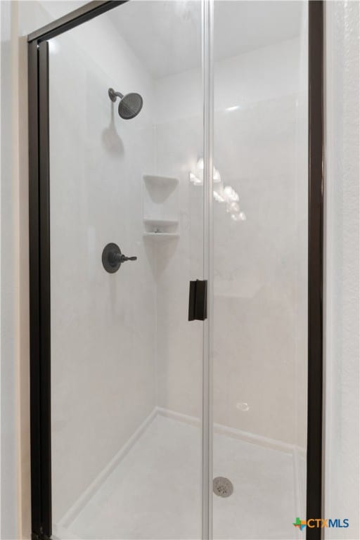 bathroom featuring a shower with door