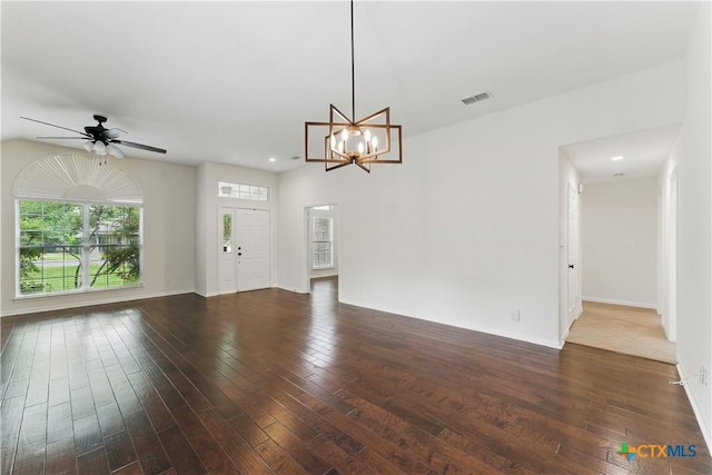 interior space with dark wood finished floors, baseboards, visible vents, and ceiling fan with notable chandelier