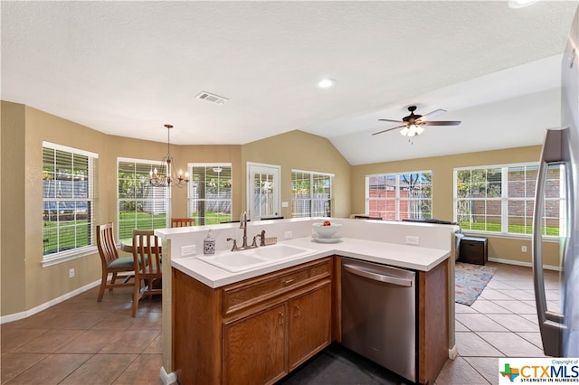 kitchen with a wealth of natural light, dishwasher, and an island with sink