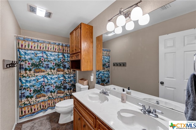 bathroom with curtained shower, vanity, and toilet