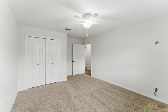 unfurnished bedroom featuring baseboards, visible vents, and carpet floors