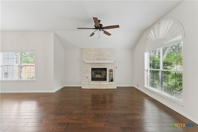 unfurnished living room with baseboards, lofted ceiling, ceiling fan, hardwood / wood-style flooring, and a fireplace