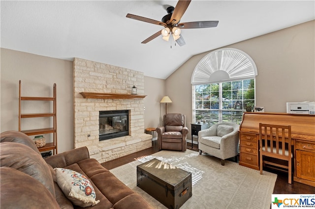 living room featuring ceiling fan, light wood-type flooring, lofted ceiling, and a fireplace