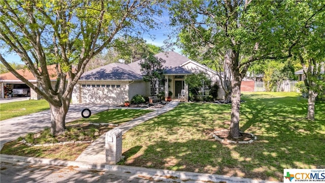 view of front of house with a front yard and a garage