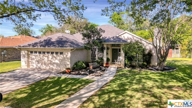 1274 Fox Glen Rd, New Braunfels, TX 78130 - view of front of property featuring a garage, brick siding, concrete driveway, and a front lawn