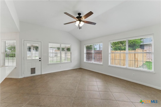 interior space with lofted ceiling, tile patterned floors, baseboards, and ceiling fan