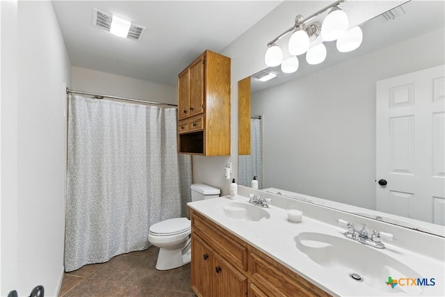 bathroom with toilet, a sink, visible vents, and double vanity