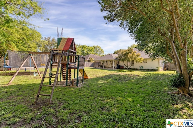 view of yard with a trampoline and a playground