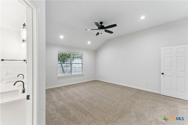 interior space featuring lofted ceiling, a ceiling fan, baseboards, and recessed lighting
