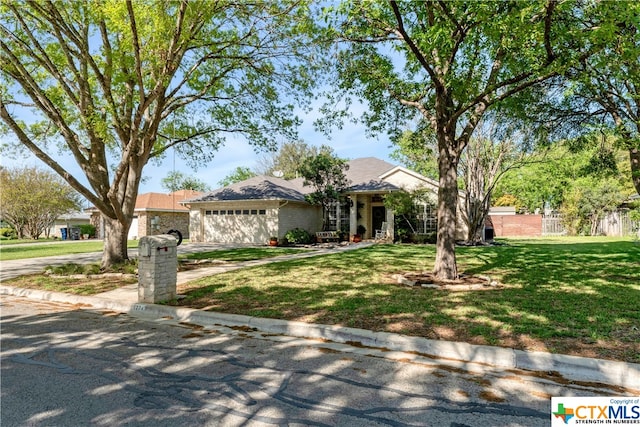 ranch-style home with a front yard and a garage