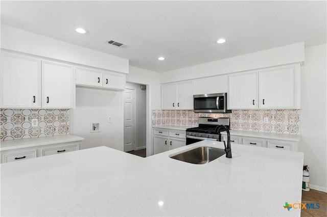 kitchen featuring light countertops, visible vents, white cabinetry, and appliances with stainless steel finishes