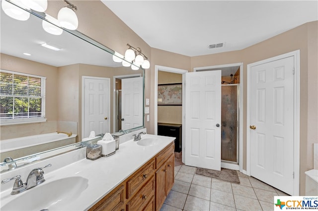 bathroom featuring tile patterned floors, vanity, and shower with separate bathtub