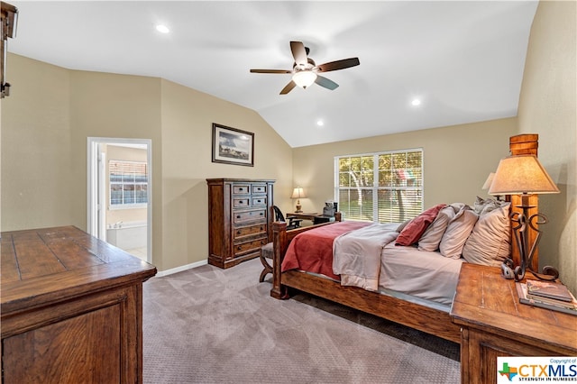 carpeted bedroom with connected bathroom, ceiling fan, and vaulted ceiling