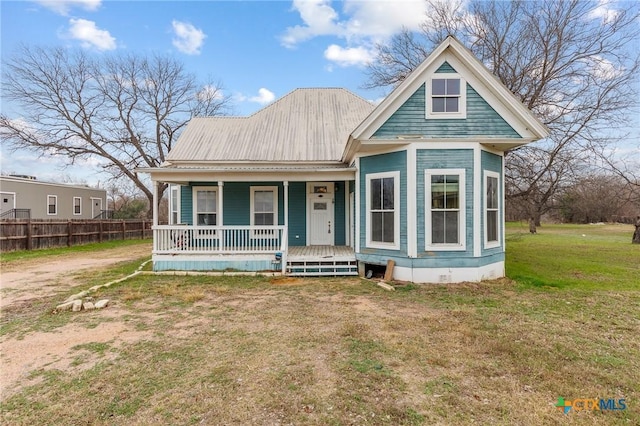 302 Avenue N, Marble Falls, TX 78654 - view of front of property featuring a porch, crawl space, metal roof, fence, and a front lawn