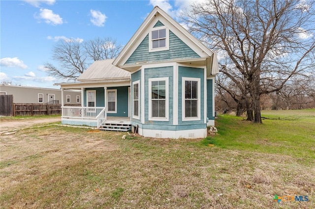 302 Avenue N, Marble Falls, TX 78654 - view of front facade with metal roof, a porch, fence, crawl space, and a front lawn