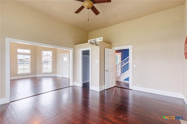 302 Avenue N, Marble Falls, TX 78654 - spare room featuring stairway, dark wood-style flooring, a ceiling fan, and baseboards