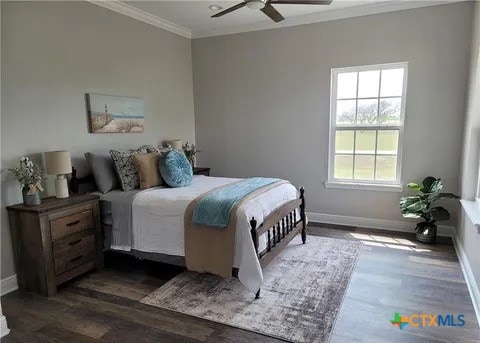 bedroom featuring dark hardwood / wood-style flooring, ornamental molding, and ceiling fan