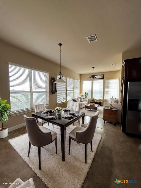 dining space featuring ceiling fan, visible vents, and baseboards