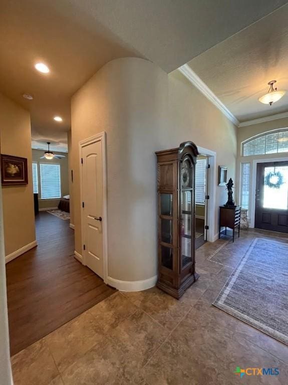 foyer with ornamental molding and baseboards