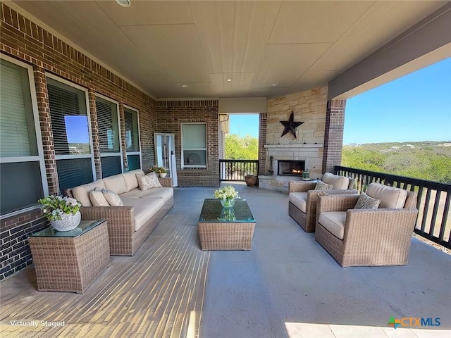 view of patio featuring an outdoor living space with a fireplace