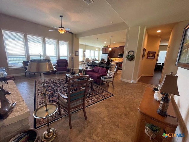 living room featuring light tile patterned floors, recessed lighting, a ceiling fan, and baseboards