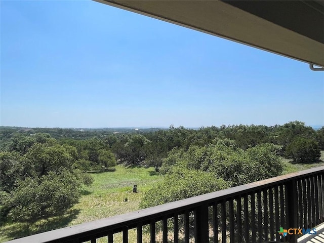 balcony featuring a forest view